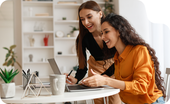 Zwei Frauen arbeiten gemeinsam an einem Laptop - flexible Zusammenarbeit für Mütter